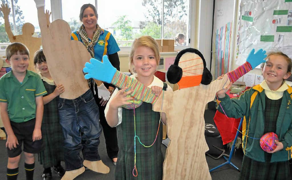 (back from left)Lucas Bradfield, Nicqui Hunt, Teacher Kristin Byrne, (front) Lily Osborne and Sophie Collins spruce up the cut-outs for Jumpers and Jazz.